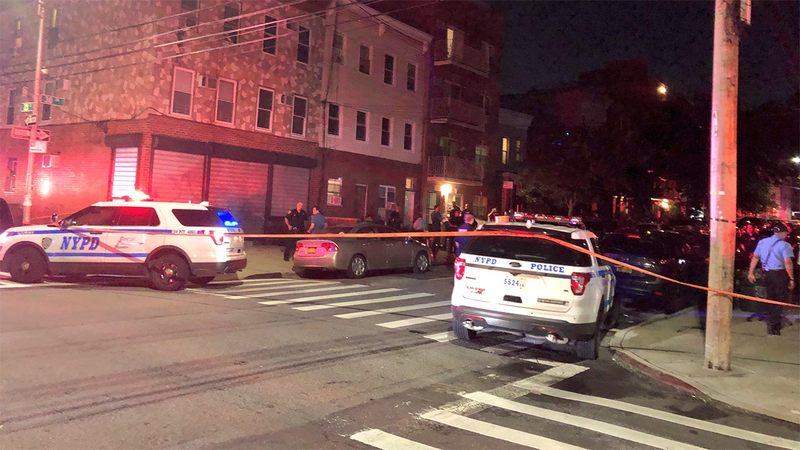 Police surround an apartment in Astoria where 4 people, including a child, were shot dead.